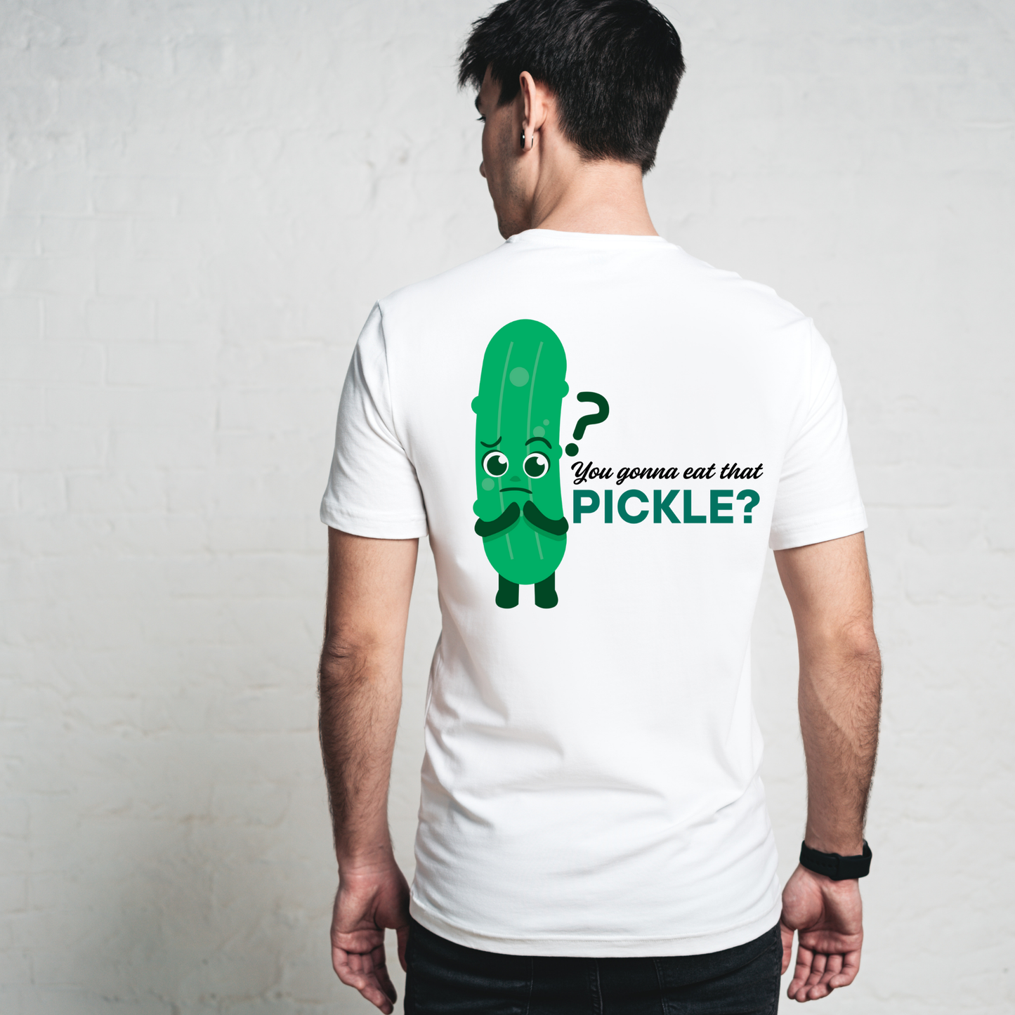 Person wearing a white t-shirt with a pickle graphic and text on the back.