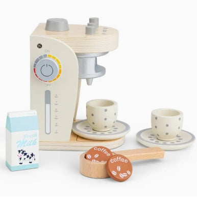 Toy coffee maker set with cups, milk carton, and coffee pods on a white background