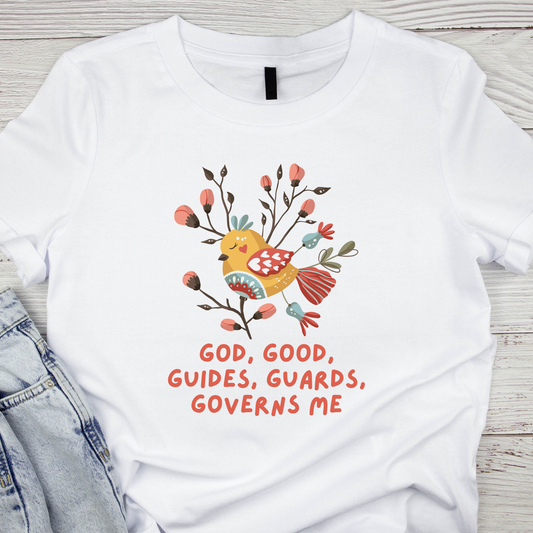 White t-shirt with a colorful bird design and text on a wooden surface