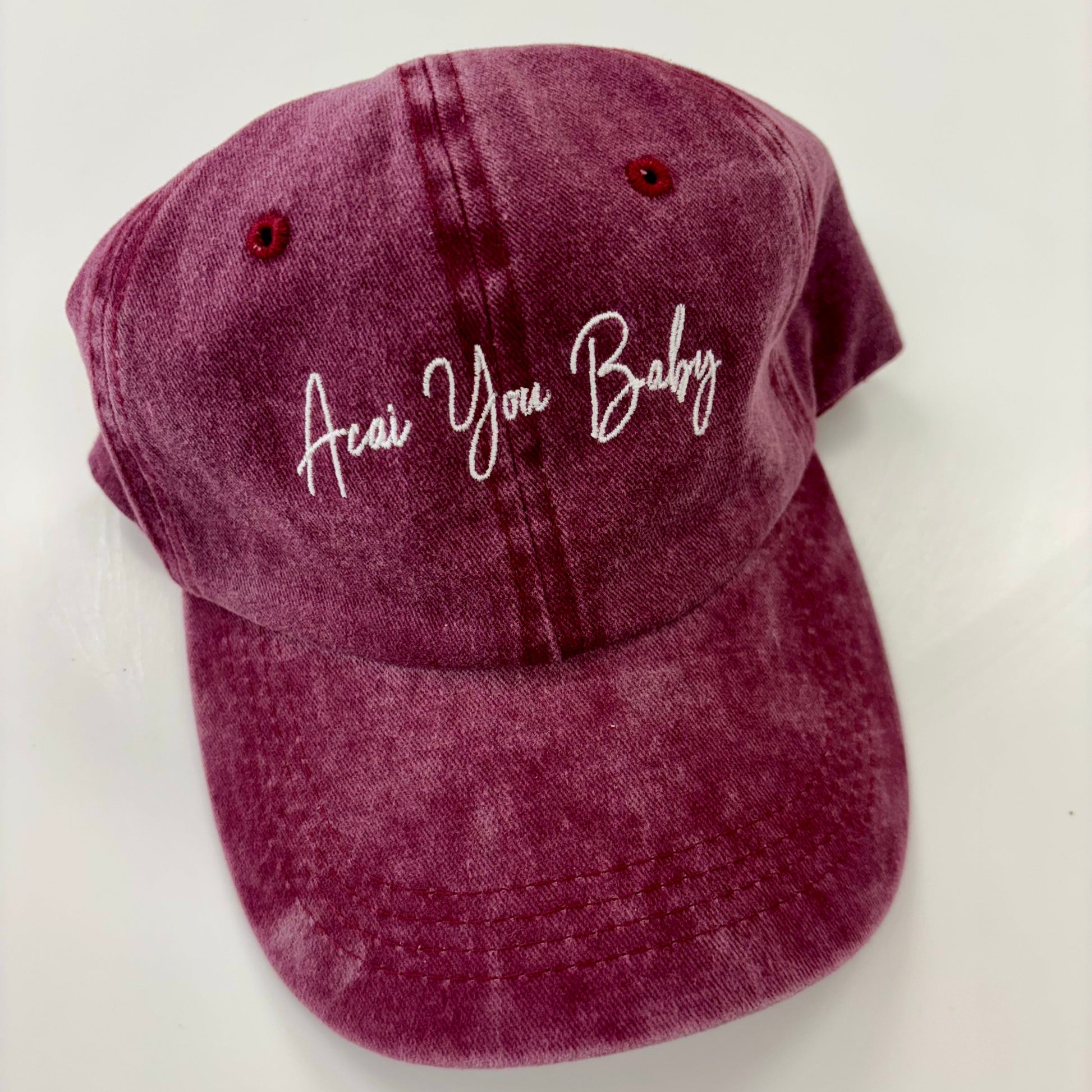 Maroon cap with 'Acai You Baby' text on a white background