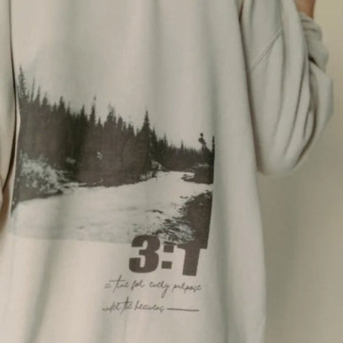 Light gray sweatshirt with a printed design of a snowy landscape and numbers on a beige background