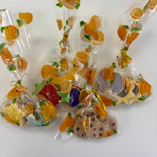 Assorted colorful dog treats in clear packaging on a white background