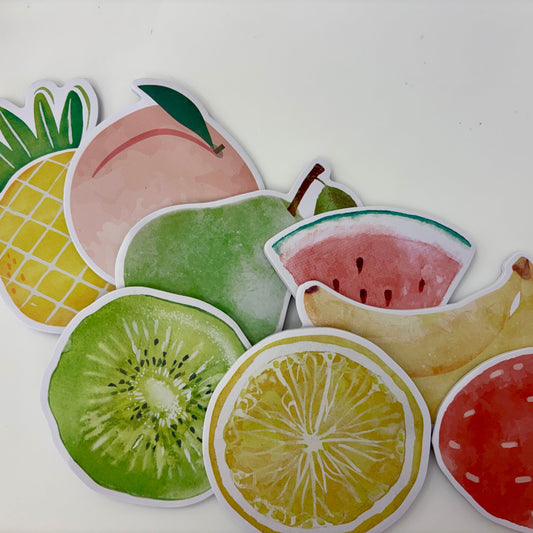 Colorful fruit-shaped stickers on a white background