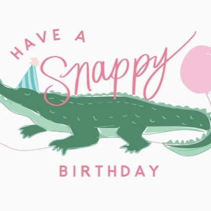 Cartoon crocodile with birthday hat and balloon, text 'Have a Snappy Birthday' on a white background