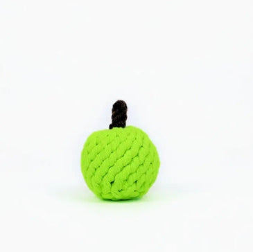 Green knitted apple-shaped toy on a white background