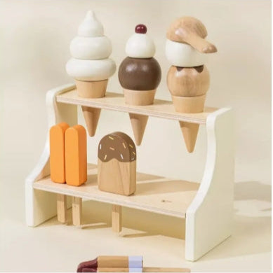 Wooden ice cream and popsicle toys on a white shelf against a beige background