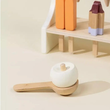 White apple-shaped object on a wooden stand with a shelf in the background