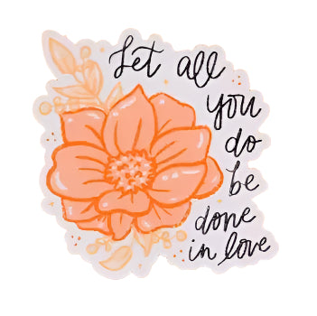 Floral sticker with text 'Let all you do be done in love' on an orange background