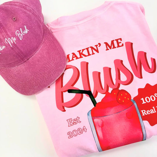 Pink t-shirt with graphic design and text, paired with a pink cap on a light background