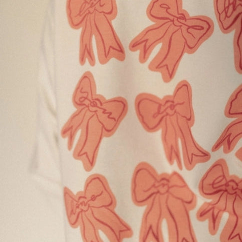 Pattern of red bows on a beige background