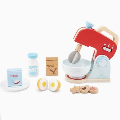 Toy kitchen set with red mixer, bowls, and various utensils on a white background