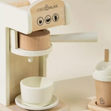 Wooden coffee machine toy with a cup on a light background