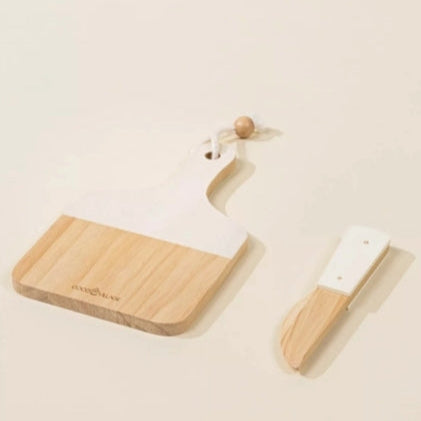 Wooden cutting board and knife with a visible brand name on a beige background