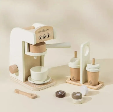 Wooden toy coffee maker set on a beige background