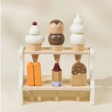 Wooden ice cream cone toys on a shelf against a plain background