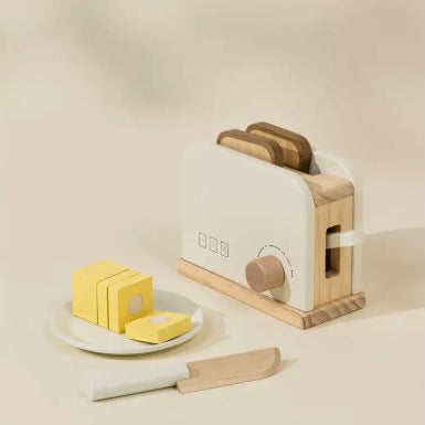 Wooden butter knife set with butter slices on a beige background