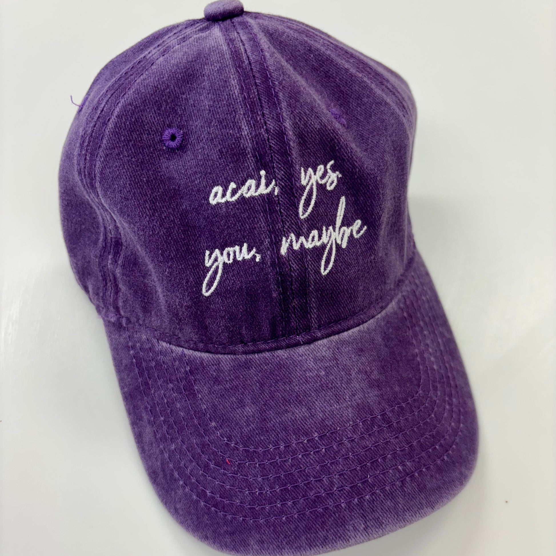 Purple cap with text on a white background