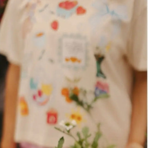 Person wearing a colorful shirt holding a potted plant