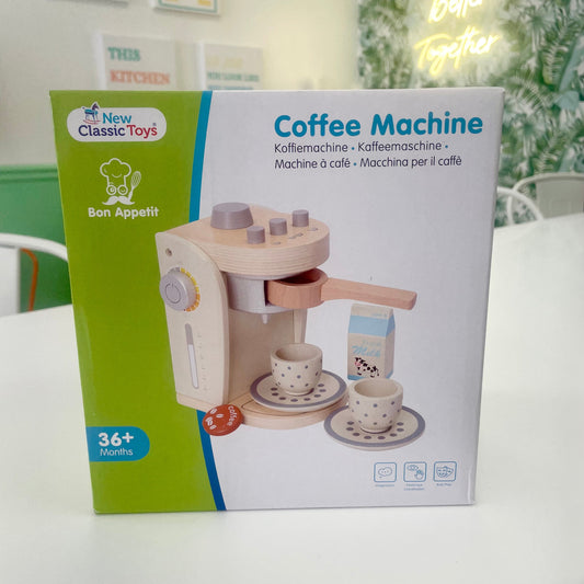Box of a toy coffee machine by New Classic Toys on a white surface.