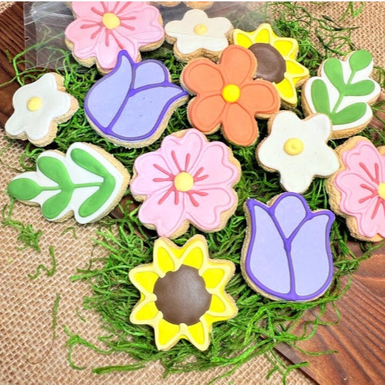 Decorative dog cookies shaped like flowers on a textured surface