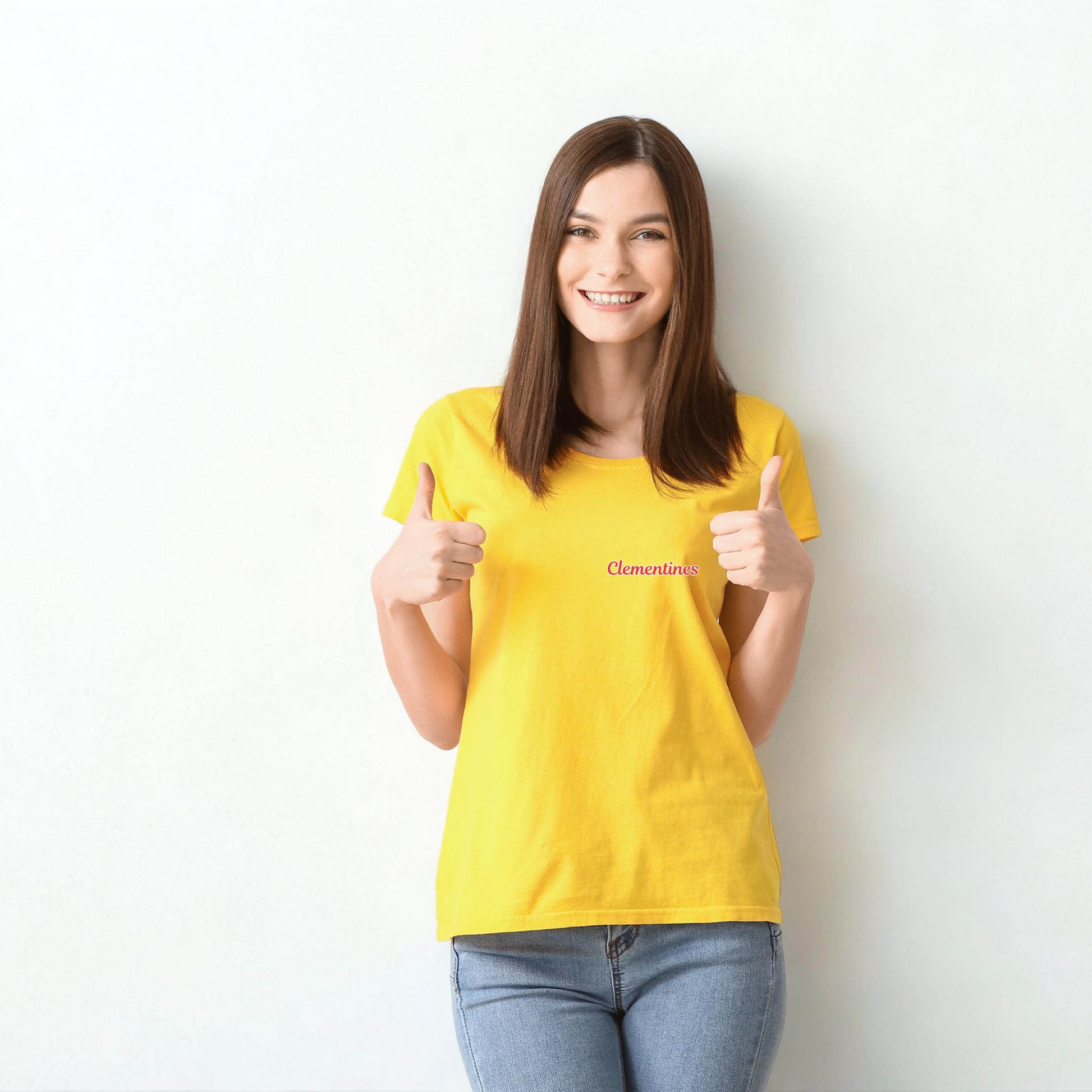 Woman wearing a yellow t-shirt with 'Clementine' text, giving a thumbs-up gesture against a white background