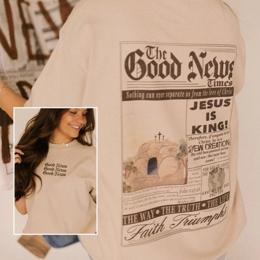 Beige t-shirt with 'The Good News Times' design featuring a cross and text.