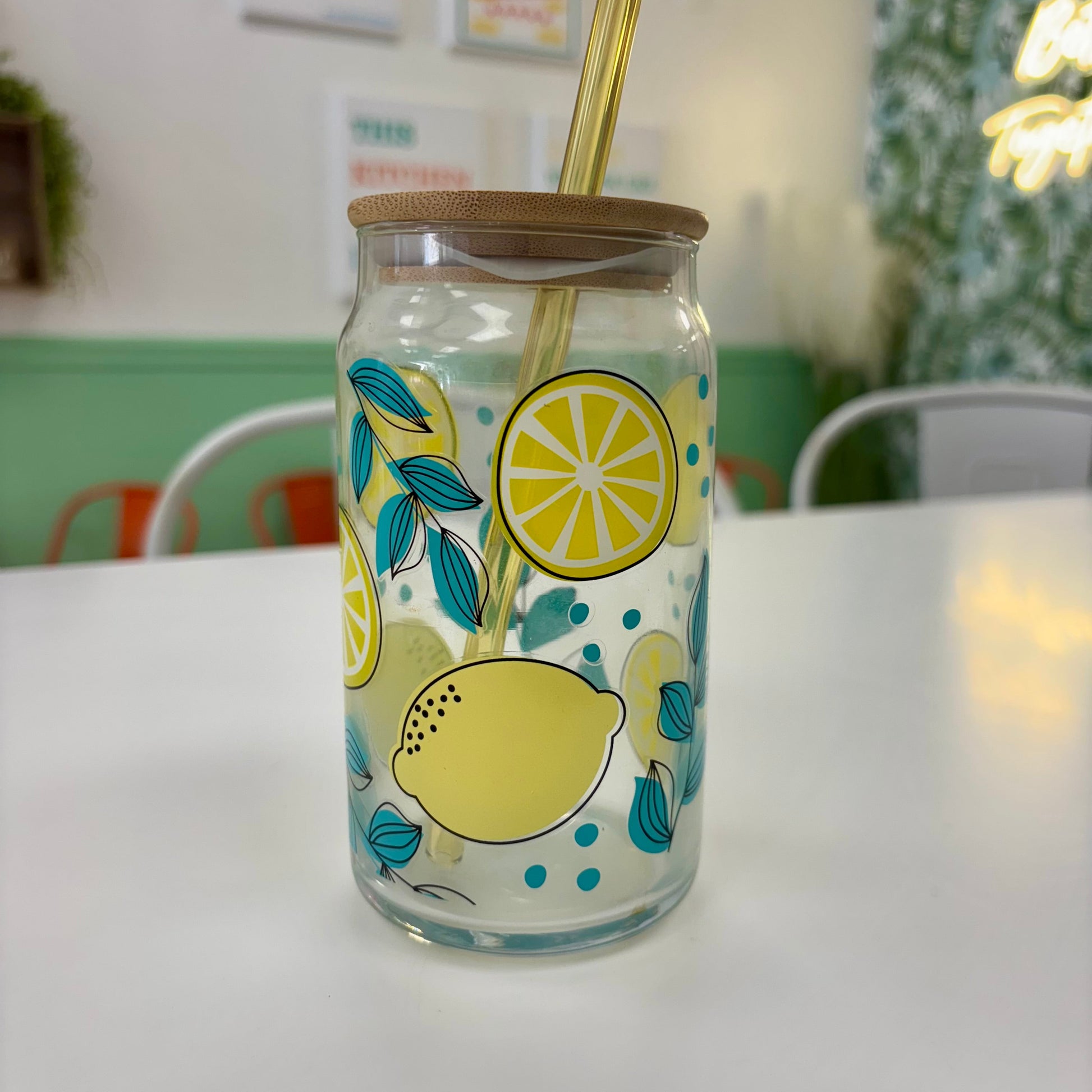 Glass tumbler with lemon design on a white table