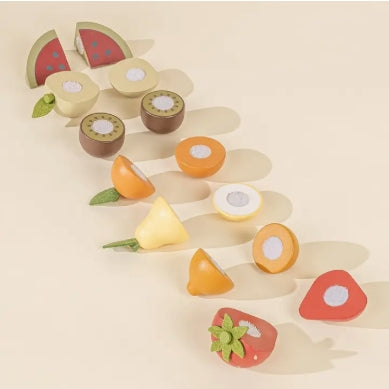 Set of wooden fruit-shaped toys on a beige background