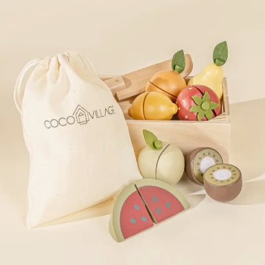 Set of wooden fruit toys with a drawstring bag branded 'Coco & Villages' on a beige background.
